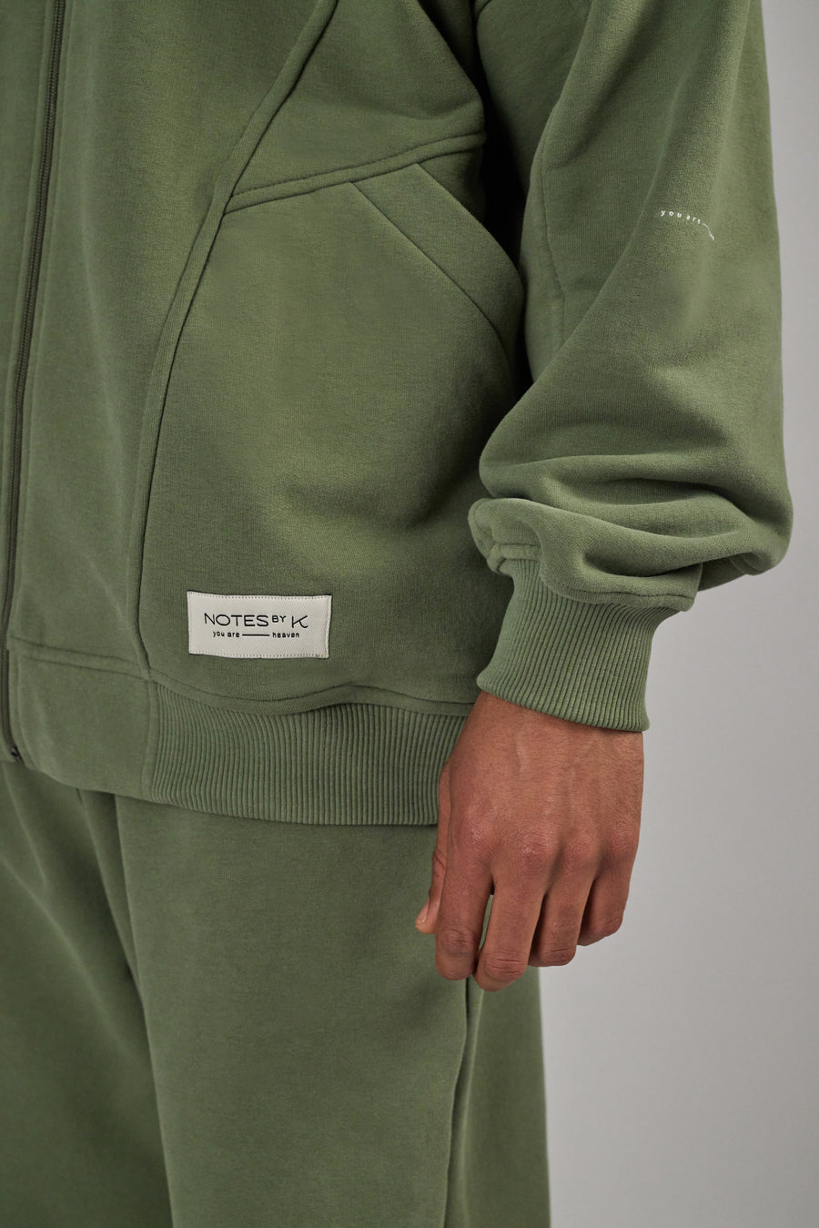 Labeling Detail on an oversized jacket in color sage green