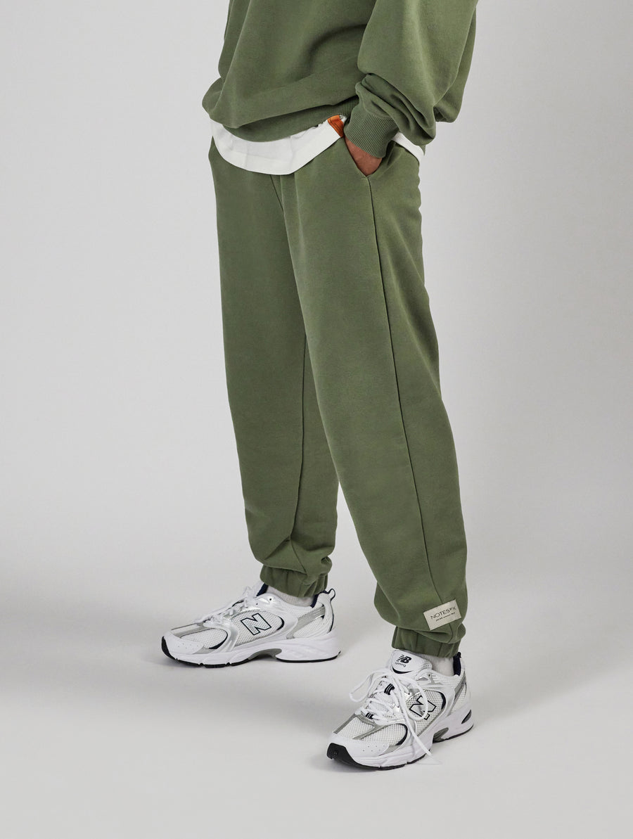 Man wearing unisex sweatpants in color sage green