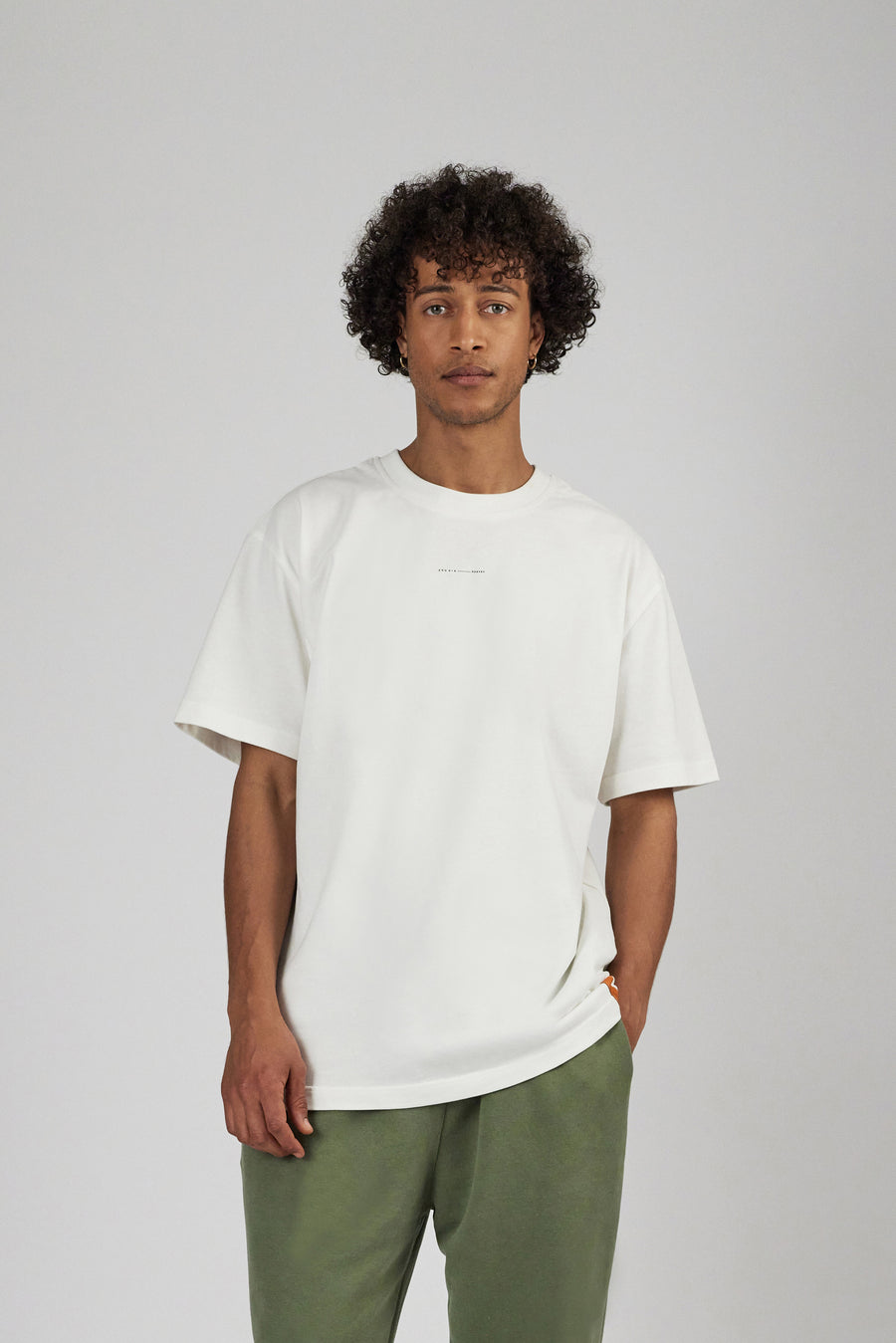 Man wearing an oversized unisex T-Shirt in color white
